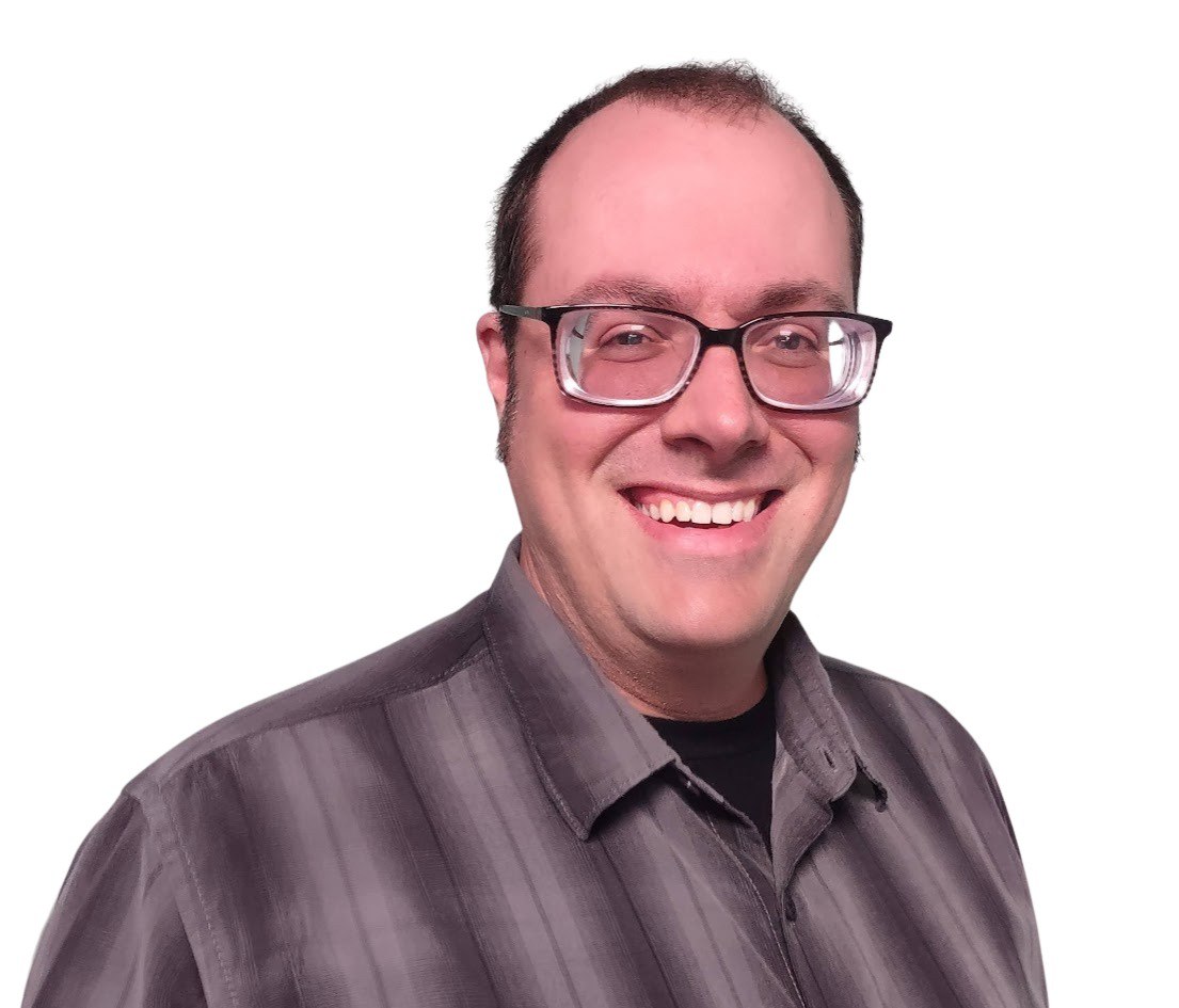 A smiling white man with short-cropped hair and glasses, in a striped shirt